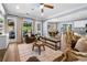 Open-concept living area with wood floors and access to a screened-in porch at 3707 Lance Bluff Ln, Duluth, GA 30097