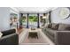 Comfortable living room with a gray sofa and view of the backyard pool at 3707 Lance Bluff Ln, Duluth, GA 30097