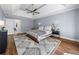 Spacious main bedroom with a tray ceiling, ceiling fan, and hardwood floors at 3707 Lance Bluff Ln, Duluth, GA 30097