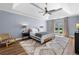Bright main bedroom featuring vaulted ceilings, ceiling fan, a large window, and hardwood floors at 3707 Lance Bluff Ln, Duluth, GA 30097
