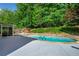 Backyard pool surrounded by lush landscaping, offering a private and serene outdoor experience at 3707 Lance Bluff Ln, Duluth, GA 30097