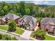 An elevated view of a home with a manicured lawn and beautiful landscaping, offering great curb appeal at 5068 Bentwater Sw Ln, Lilburn, GA 30047
