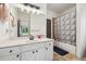 Bathroom with a vanity, mirror, and shower with a patterned curtain at 5068 Bentwater Sw Ln, Lilburn, GA 30047