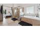 Bright bathroom with a walk-in shower, soaking tub, and views of the main bedroom at 5068 Bentwater Sw Ln, Lilburn, GA 30047