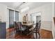 Elegant dining room with a modern chandelier, dark wood floors, and wainscoting at 5068 Bentwater Sw Ln, Lilburn, GA 30047
