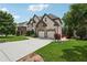 Charming brick home with a stone facade, mature trees, and a long driveway at 5068 Bentwater Sw Ln, Lilburn, GA 30047