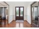 Welcoming foyer features hardwood flooring and doors with frosted windows at 5068 Bentwater Sw Ln, Lilburn, GA 30047