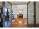 View through French doors into entry hall with hardwood floors and dining room in the background at 5068 Bentwater Sw Ln, Lilburn, GA 30047