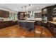 The kitchen features dark wood cabinetry, granite countertops, mosaic backsplash, and hardwood flooring at 5068 Bentwater Sw Ln, Lilburn, GA 30047