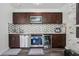 Kitchen with dark cabinetry, stainless steel appliances, and a mosaic backsplash at 5068 Bentwater Sw Ln, Lilburn, GA 30047