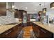 Gourmet kitchen with granite counters, mosaic tile backsplash, stainless steel appliances, and hardwood flooring at 5068 Bentwater Sw Ln, Lilburn, GA 30047