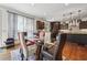 Open-concept kitchen features dark cabinets, granite countertops, stainless appliances, and modern lighting at 5068 Bentwater Sw Ln, Lilburn, GA 30047