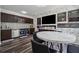 Kitchen and dining area with stainless steel appliances, dark cabinetry, and a center island at 5068 Bentwater Sw Ln, Lilburn, GA 30047