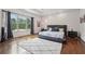 Bright bedroom with hardwood floors, a large window, and stylish furnishings at 5068 Bentwater Sw Ln, Lilburn, GA 30047