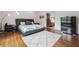 Bedroom featuring hardwood floors, a white rug, and modern furniture at 5068 Bentwater Sw Ln, Lilburn, GA 30047