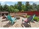 Paver patio featuring an outdoor stone seating area with colorful Adirondack chairs and a fire pit at 5068 Bentwater Sw Ln, Lilburn, GA 30047