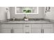 Bright bathroom featuring a double sink vanity with marble countertop and white cabinetry at 770 Ormewood Se Ave, Atlanta, GA 30312