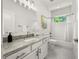 Bathroom with single sink vanity, shower-tub combo, and black-and-white mosaic floor at 770 Ormewood Se Ave, Atlanta, GA 30312