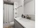 Bright bathroom with a clean design, featuring a shower with a patterned curtain, and a sleek gray vanity at 770 Ormewood Se Ave, Atlanta, GA 30312