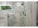 Bathroom featuring a glass-enclosed shower with marble tile and black-and-white mosaic floor at 770 Ormewood Se Ave, Atlanta, GA 30312