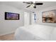 Comfortable bedroom with a modern ceiling fan, wall-mounted TV, and contemporary decor, perfect for relaxation at 770 Ormewood Se Ave, Atlanta, GA 30312