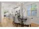 Open dining area featuring hardwood floors, modern light fixtures and a large window at 770 Ormewood Se Ave, Atlanta, GA 30312