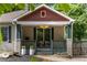 Inviting front porch with decorative columns, seating, and beautiful landscaping at 770 Ormewood Se Ave, Atlanta, GA 30312