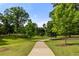 Beautiful winding sidewalk path through lush green lawns and mature trees at 770 Ormewood Se Ave, Atlanta, GA 30312