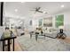 Bright, open-concept living room with modern furnishings and hardwood floors, seamlessly connecting to the kitchen and dining area at 770 Ormewood Se Ave, Atlanta, GA 30312
