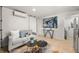 Bright living area with modern furnishings, including a stylish sofa, unique accent tables, and contemporary artwork at 770 Ormewood Se Ave, Atlanta, GA 30312