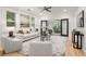 Bright living room with hardwood floors, modern furniture, and double doors leading to a sunroom at 770 Ormewood Se Ave, Atlanta, GA 30312
