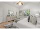 Bright main bedroom with a large window, a dresser, hardwood floors and a bed with lots of pillows at 770 Ormewood Se Ave, Atlanta, GA 30312
