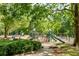 Fun playground with slides, climbing structures, and swings, surrounded by mature trees and lush greenery at 770 Ormewood Se Ave, Atlanta, GA 30312