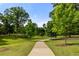 Scenic walking path winding through lush green spaces with mature trees and well-maintained landscaping at 770 Ormewood Se Ave, Atlanta, GA 30312