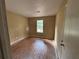 A bedroom featuring hardwood floors, a window, and a door at 1090 Forest Path, Stone Mountain, GA 30088