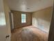 A bedroom featuring plywood floors, a window, and a door at 1090 Forest Path, Stone Mountain, GA 30088