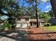 Charming split-level home features a two-car garage and a welcoming front porch at 1090 Forest Path, Stone Mountain, GA 30088