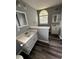 Bright bathroom featuring dual vanities, a window, and modern fixtures at 1201 Saint Andrews Dr, Auburn, GA 30011