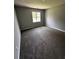 Comfortable bedroom featuring soft carpeting, neutral walls, and a bright window at 1201 Saint Andrews Dr, Auburn, GA 30011