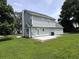 Back view of a two-story home with light blue siding and a small concrete patio at 1201 Saint Andrews Dr, Auburn, GA 30011