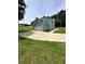 Side view of a two-story home with light blue siding and an attached garage on a grassy lawn at 1201 Saint Andrews Dr, Auburn, GA 30011