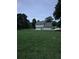 A wide grassy lawn with a view of a two-story home with light blue siding and an attached garage at 1201 Saint Andrews Dr, Auburn, GA 30011