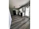 Modern kitchen features white cabinets, black appliances, subway tile backsplash and gray wood-look flooring at 1201 Saint Andrews Dr, Auburn, GA 30011