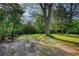 View of backyard space featuring picnic tables surrounded by trees at 2228 Emory St, Covington, GA 30014