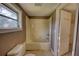 Bathroom featuring a tub/shower combination, toilet and a window for natural light at 2228 Emory St, Covington, GA 30014
