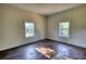 Bedroom featuring hardwood floors and natural light through windows at 2228 Emory St, Covington, GA 30014
