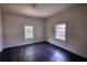 Bedroom featuring two windows and beautiful hardwood flooring at 2228 Emory St, Covington, GA 30014