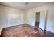 Spacious bedroom with hardwood flooring and an open doorway at 2228 Emory St, Covington, GA 30014