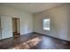 A bedroom featuring hardwood floors and a large window at 2228 Emory St, Covington, GA 30014