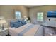 Staged bedroom featuring a bed, side tables, lamps, and dresser at 2228 Emory St, Covington, GA 30014